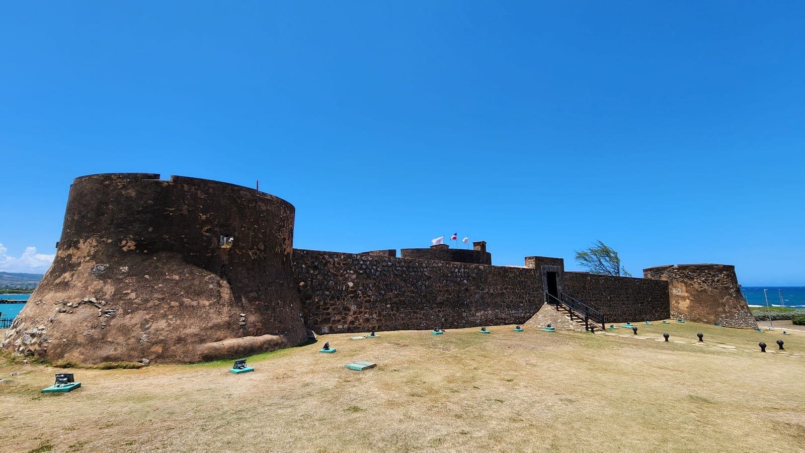 The stone walls and rounded bastions of the 16th-century Fortaleza San Felipe in Puerto Plata