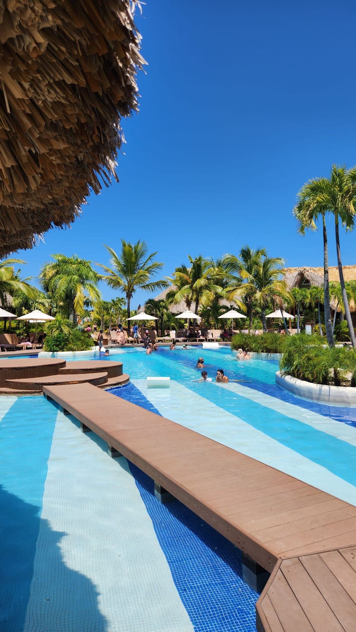 A lazy river pool with a wooden walkway at the Taino Bay cruise terminal's pool complex