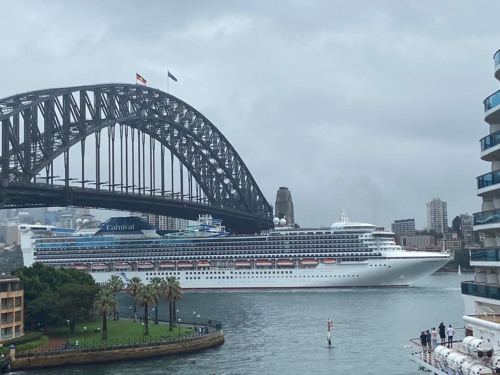 Carnival Adventure cruise ship passing beneath the Sydney Harbour Bridge