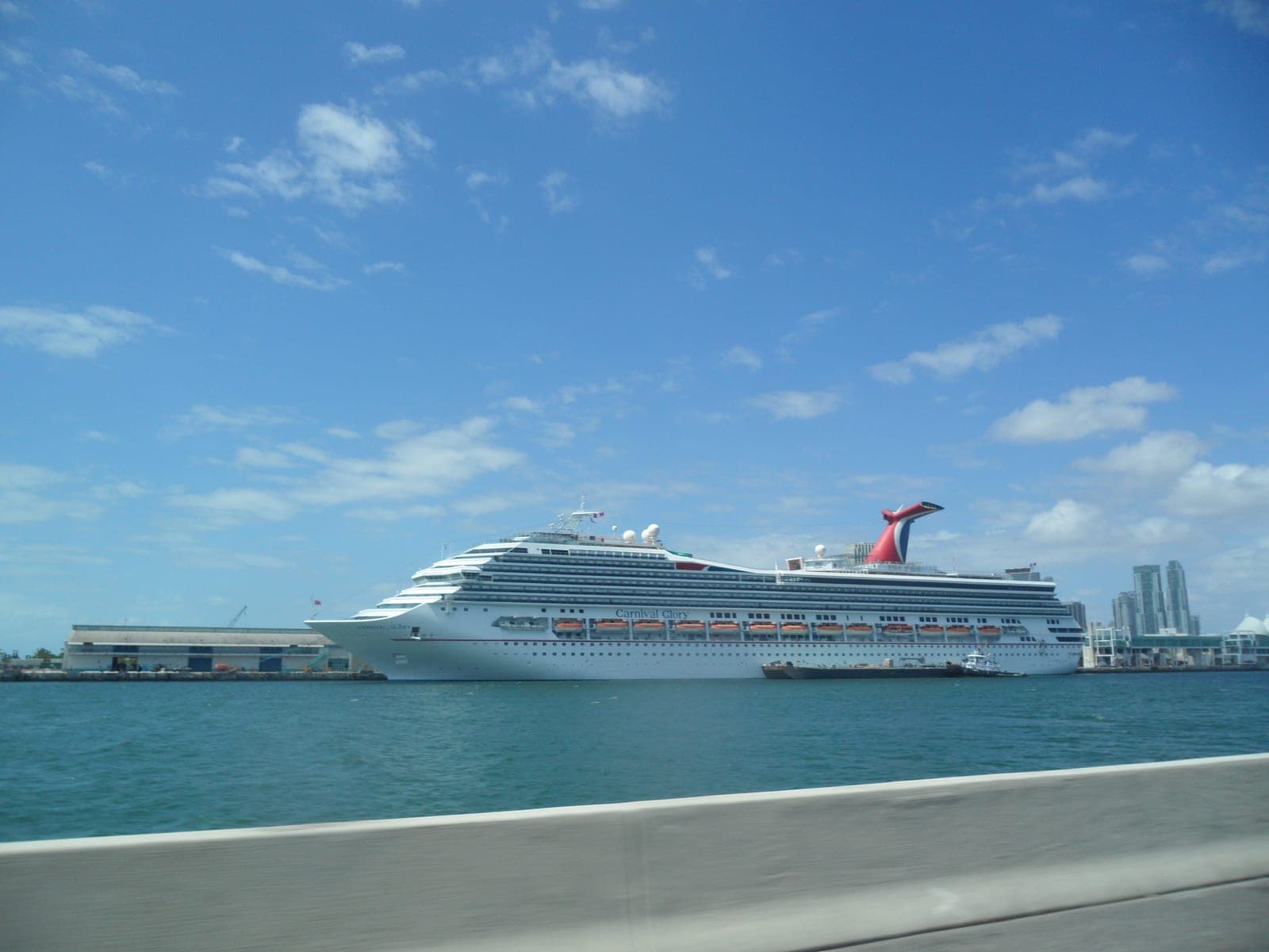 Carnival Glory cruise ship docked in Miami, showing her red, white, and blue whale-tail funnel