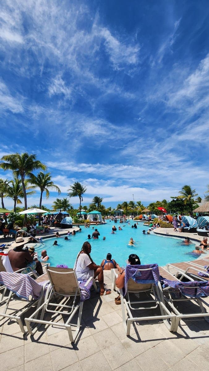 Grand Turk Cruise Center beach with turquoise water, loungers, umbrellas, and palm trees