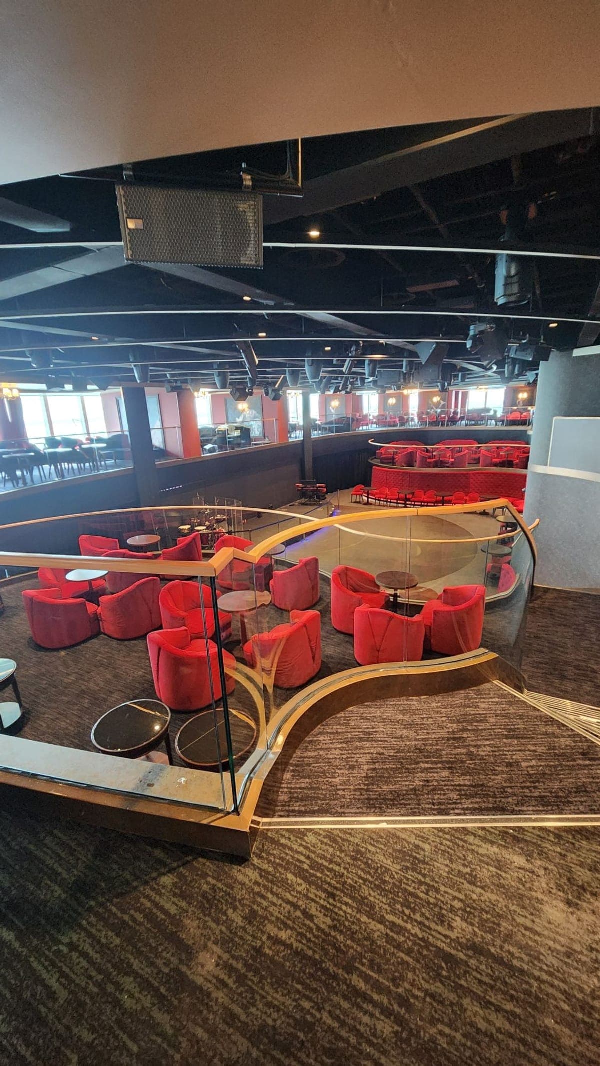 MSC Seashore's Carousel Lounge with red velvet seating arranged around a multi-level dance floor