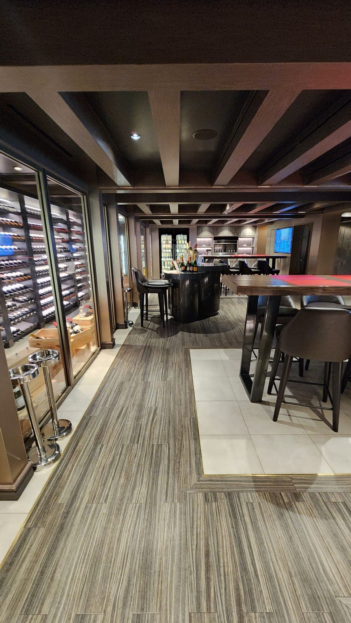 A private wine cellar and dining room aboard MSC Seashore lined with wine racks