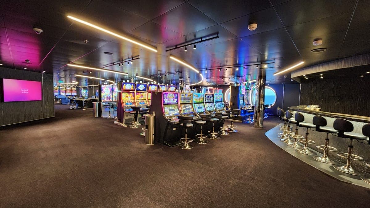 Resilient Lady casino with colorful slot machines, gaming tables, and blue accent lighting